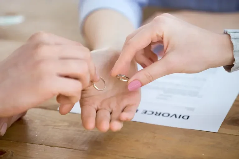 Two spouses who are getting an uncontested divorce hand over their rings when signing their paperwork.