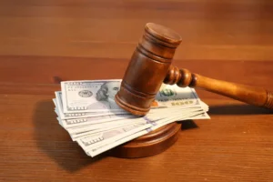 A gavel is set on top of cash, representing uncontested divorce and alimony.