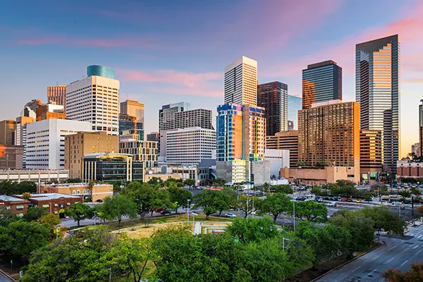 Houston skyline featuring modern skyscrapers and urban greenery, representing a vibrant city of culture and innovation in Texas.