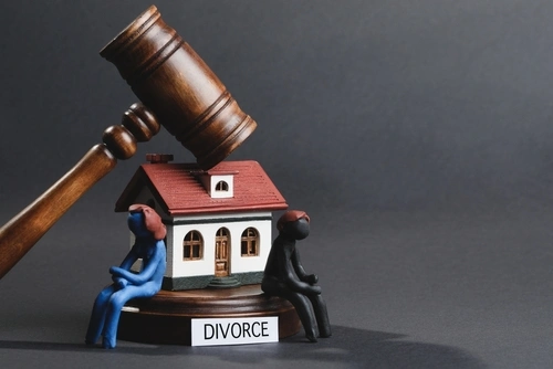 Joint mortgage in an uncontested divorce concept, model house and word divorce